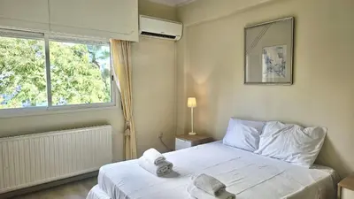 a bedroom with a bed with white sheets and a window at STAY Charm Classic Apartment in Strovolos