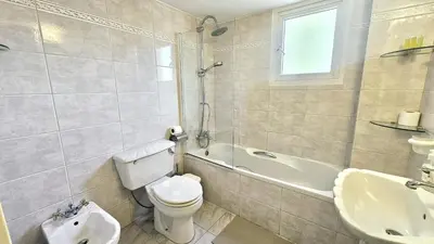 a bathroom with a toilet and a tub and a sink at STAY Charm Classic Apartment in Strovolos