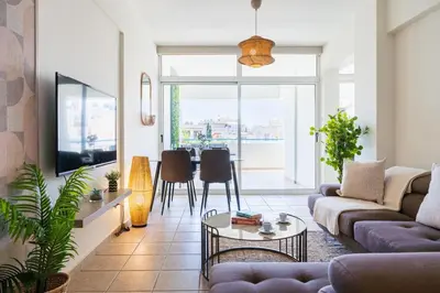 a living room with a couch and a table at Yellow Canvas - 2-BR Apartment & Balcony in Larnaca in Larnaka