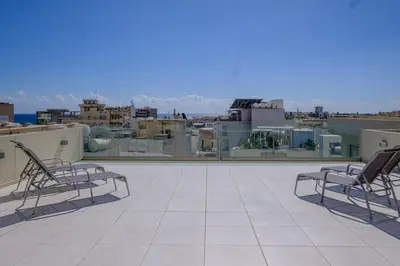 two chairs sitting on top of a roof at Downtown Sea View Penthouse in Larnaka