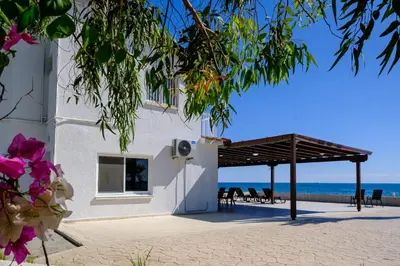 a view of the beach from the side of a building at Shoreline Beach House in Larnaka