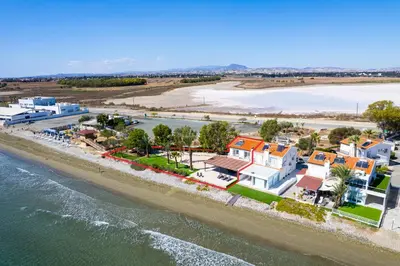 an aerial view of a town next to the water at Shoreline Beach House in Larnaka