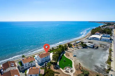 an aerial view of a beach with a red marker at Shoreline Beach House in Larnaka