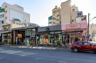a red car parked on the side of a city street at Lena Court - Spacious 3bdr, City Views in Limassol