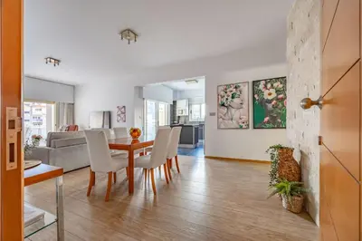 a living room with a table and chairs at Lena Court - Spacious 3bdr, City Views in Limassol