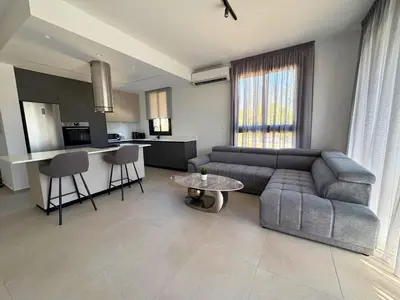a living room with a couch and a table at Hypnos Park View in Nicosia