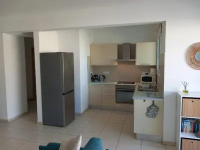a kitchen with a stainless steel refrigerator and cabinets at Casa Luna in Paralimni