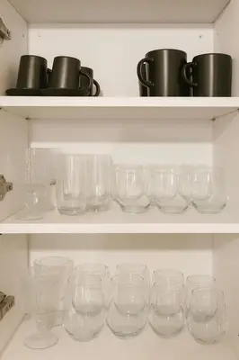 a bunch of glasses sitting on a shelf at Alasia Apt-2Bdr in Nicosia