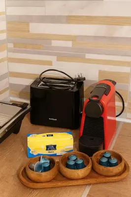 a table with a toaster a toaster and a box at Alasia Apt-2Bdr in Nicosia