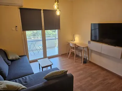 a living room with a couch and a flat screen tv at Alasia Apt-2Bdr in Nicosia