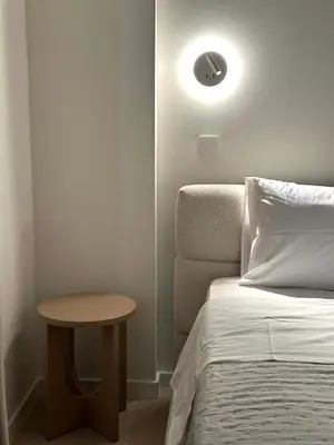 a bedroom with a bed and a table next to a bed at Idei-Eos Charming & Comfort Apartment in Nicosia