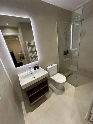 a bathroom with a sink and a toilet and a mirror at Idei-Eos Charming & Comfort Apartment in Nicosia