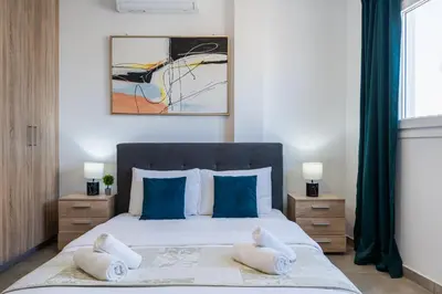 a bedroom with a bed with two towels on it at Hilltop 2-Bedroom Apartment in Larnaka
