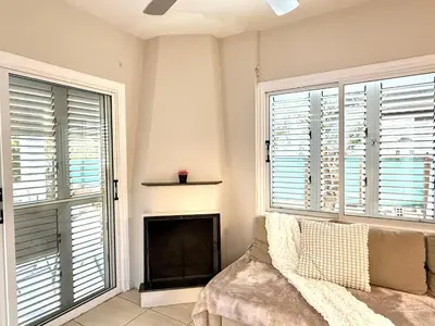 a living room with a couch and two windows at Onyx Beach Villa - Cozy 2BR - Walk to Beach in Meneou