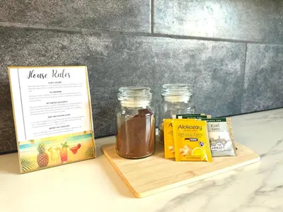 a wooden tray with two jars of honey and a box at Onyx Beach Villa - Cozy 2BR - Walk to Beach in Meneou