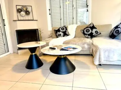 a living room with two tables and a couch at Onyx Beach Villa - Cozy 2BR - Walk to Beach in Meneou