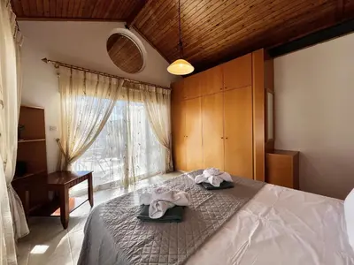 a bedroom with a bed with towels on top of it at STAY Agapi Sea view Villa in Pissouri