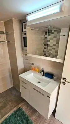 a bathroom with a sink and a mirror at Dasoudi Pecora Beach Apartment in Limassol