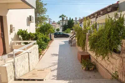 an alley with a car parked on a street at Bluewave Apartment in Pyla