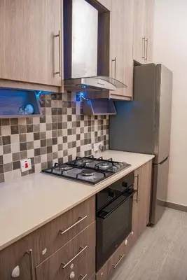 a kitchen with a stove and a refrigerator at Bluewave Apartment in Pyla