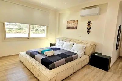 a bedroom with a large bed with a teddy bear on it at Pareklisia Mystical Haven in Parekklisha
