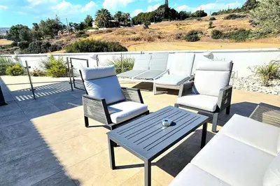 a group of chairs and a table on a patio at Pareklisia Mystical Haven in Parekklisha