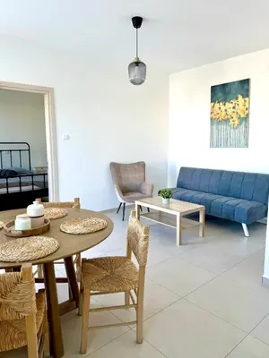 a living room with a table and a blue couch at Kiti Traditional Residences in Larnaka