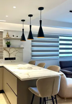a kitchen with a island with chairs and pendant lights at Sweet Luxury 2BR Nicosia City in Nicosia