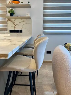 a kitchen with a table with two chairs and a counter at Sweet Luxury 2BR Nicosia City in Nicosia