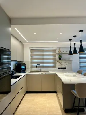 a kitchen with white cabinets and a sink at Sweet Luxury 2BR Nicosia City in Nicosia