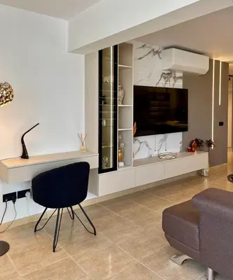 a living room with a tv and a chair and a couch at Sweet Luxury 2BR Nicosia City in Nicosia
