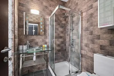 a bathroom with a shower and a sink at Parkside 2 Bedroom Apartment in Larnaka