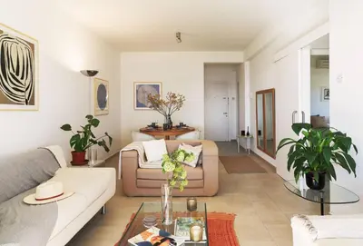 a living room with a couch and a table at Melon Boutique Seafront Apartment in Limassol