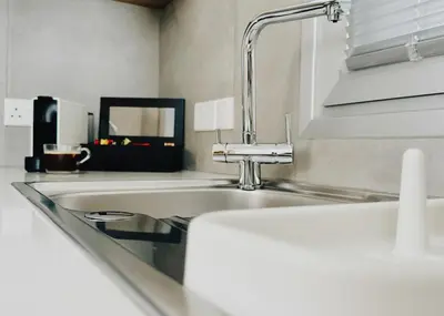 a kitchen with a sink and a faucet at Grace Living in Limassol