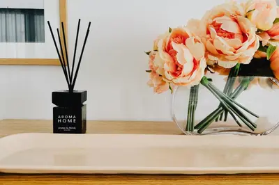 a vase filled with pink flowers on a table at Grace Living in Limassol
