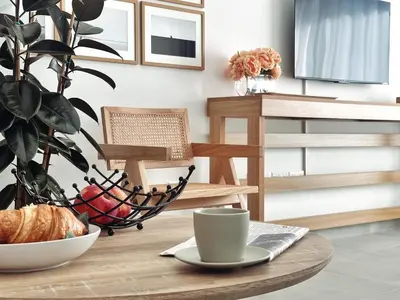 a table with a coffee cup and a bowl of fruit at Grace Living in Limassol