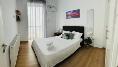 a bedroom with a large bed with white sheets at 3 bedroom villa in Voroklini