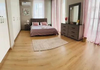 a bedroom with a bed and a large mirror at 3 bedroom villa in Voroklini