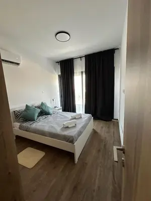 a bedroom with a bed with green pillows and a window at Villa - Sleeps 6 - Near Local Attractions in Limassol