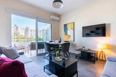 a living room with a couch and a table at Ondo 2-Bedroom Apartment in Larnaka