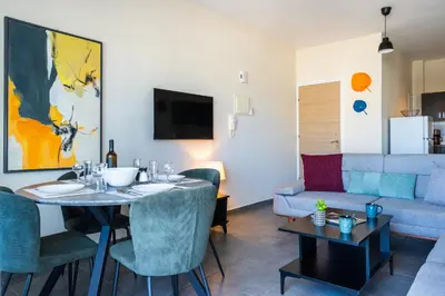 a living room with a table and a couch at Ondo 2-Bedroom Apartment in Larnaka