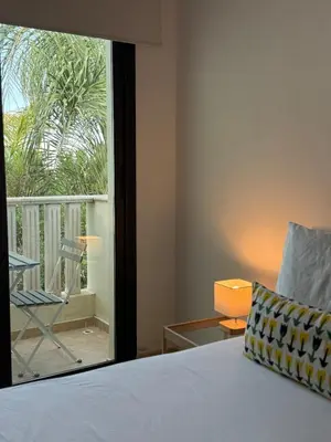 a bedroom with a bed and a view of a balcony at NEW - Agia Marina - Rural Retreat with Shared Pool & Parking in Avgorou