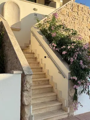 a staircase with flowers on the side of a house at NEW - Agia Marina - Rural Retreat with Shared Pool & Parking in Avgorou
