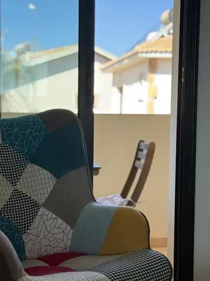 a chair sitting in front of a window at NEW - Agia Marina - Rural Retreat with Shared Pool & Parking in Avgorou