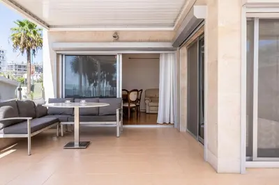 a living room with a couch and a table at Beachfront Luxury Living Limassol in Limassol