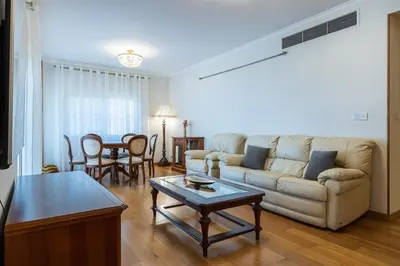 a living room with a couch and a table at Beachfront Luxury Living Limassol in Limassol
