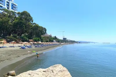 a person standing in the water on a beach at Beachfront Luxury Living Limassol in Limassol