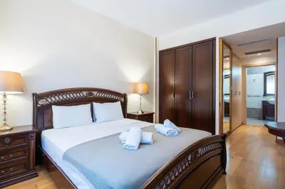 a bedroom with a bed with two towels on it at Beachfront Luxury Living Limassol in Limassol