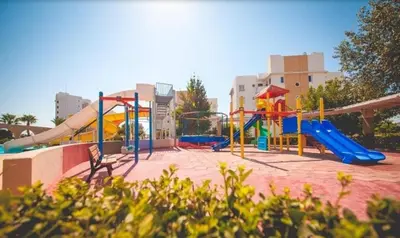 a playground with a slide at THE PALMiA I iskele I Trikomo in Aglantzia