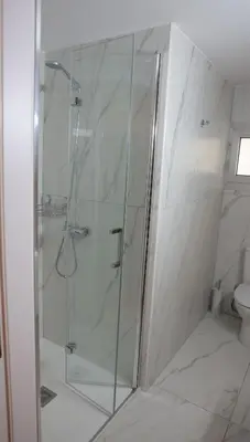a shower with a glass door in a bathroom at ELIA Elegant Central Suite Larnaca in Larnaka